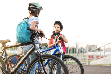 Canvas Print - Cute children riding bicycles outdoors