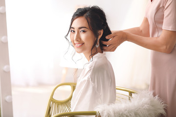 Poster - Professional hairdresser working with young Asian bride at home