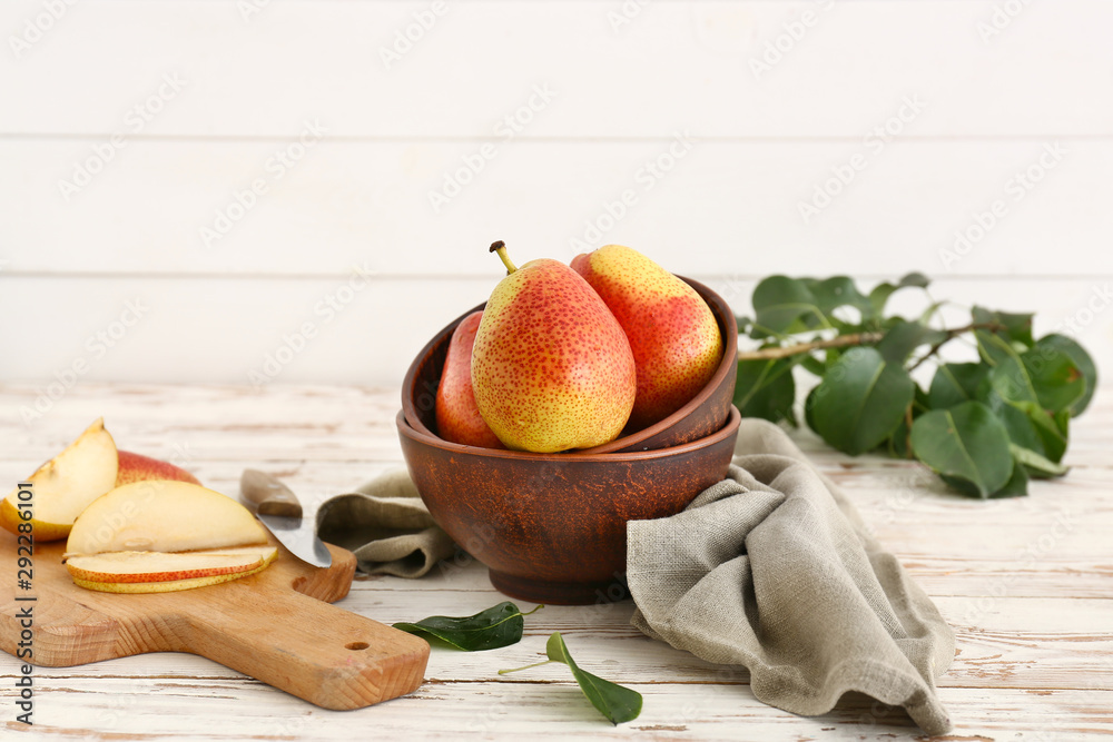Tasty fresh pears on white wooden table
