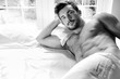 © Tony Marturano - Handsome hairy naked muscular man with beard sixpack abs lying in bed covered with sheet