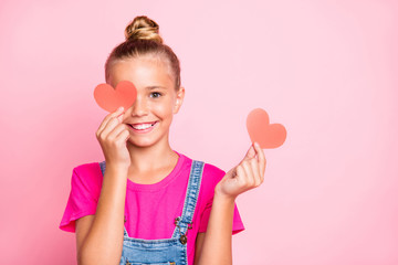 Copyspace photo of cute nice cheerful girl looking out of red heart ahspe smiling toothily wearing fuchsia t-shirt jeans denim isolated over pink pastel color background