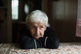 Fototapeta  - Portrait of a sad old woman. Care for lonely pensioners.