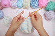 Women's hobby. Crochet and knitting. Yarns in basket with crochet hooks Multiple crocheting tools, crocheting supplies.