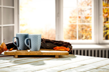 Canvas Print - Autumn desk with mug and blurred fall window space 