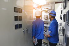 Maintainance Man Working With Team Work On Power Control Of The Factory
