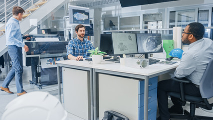 Fototapete - In the Busy Engineering Facility: Diverse Group of Engineers, Technicians, Specialists Working on Design for Industrial Engine Prototype. Professionals Talk, Work with Drawings, Use Computers