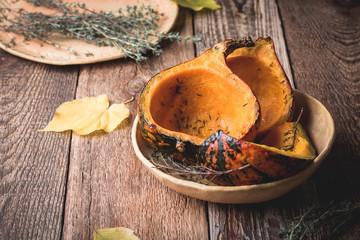 Wall Mural - Baked pumpkins with thyme on rustic table