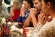 © Syda Productions - holidays and religious concept - close up of friends having christmas dinner and praying before meal