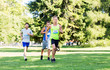 © Syda Productions - fitness, sport, race and healthy lifestyle concept - group of happy people or male sportsmen running marathon with badge numbers at summer park