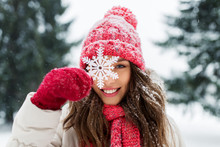 People, Season And Christmas Concept - Portrait Of Happy Smiling Teenage Girl Or Young Woman With Snowflake In Winter Park