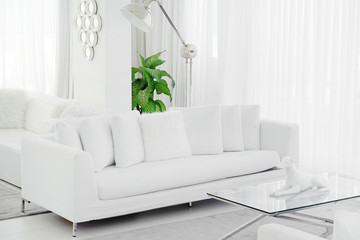 Interior of the living room of the hotel. Beautiful living room with white sofa. White Concept Living Room Interior. Modern bed room interior in Luxury villa. White colours, big window