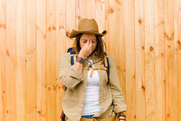 young latin explorer woman against wooden wall background