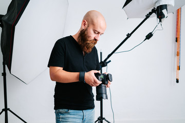 Wall Mural - an photographer with camera in studio