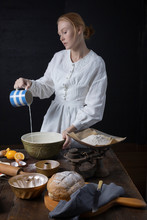 Victorian Woman Baking In A Vintage Kitchen