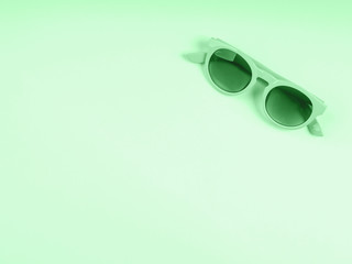 Canvas Print - Monochrome green sun glasses flat lay. Mint green color of 2020