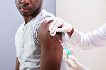 Doctor Making Vaccine Injection With Syringe