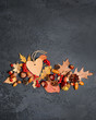 autumn background. harvest season. Paper heart tag, acorns, leaves, nuts and cones on rustic wooden table. autumn holiday, fall time, thanksgiving, halloween concept. copy space