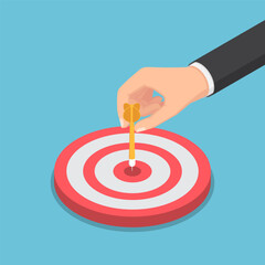 Isometric businessman hand putting dart arrow on center of the bullseye