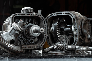 Wall Mural - Dismantled car gearbox with gears, close-up. Repair box predach, repair of used cars. Metal background.