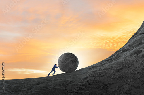 Cuadros en Lienzo Man pushing large stone to the top