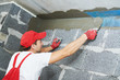 © Kadmy - plasterer worker protecting corner with mesh. building technology