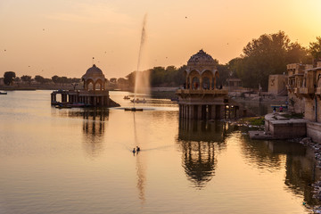 Wall Mural - Gadisar lake on sunset. Man-made water reservoir with temples in Jaisalmer. India