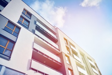 Modern apartment buildings on a sunny day with a blue sky. Facade of a modern apartment building.Glass surface with sunlight.