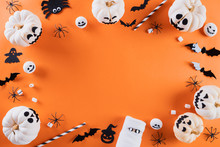 Top View Of Halloween Crafts, Orange Pumpkin, Ghost, Bat And Spider On Orange Background With Copy Space For Text. Halloween Concept.