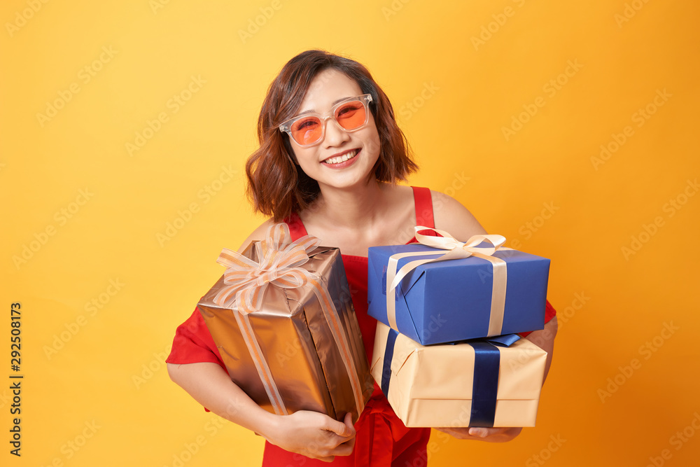 Portrait of casual young happy smiling woman hold gift box. Stock Photo ...