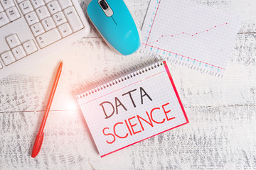 Conceptual hand writing showing Data Science. Concept meaning multidisciplinary field that uses scientific methods Wood desk office appliance computer equipaments charts paper slot