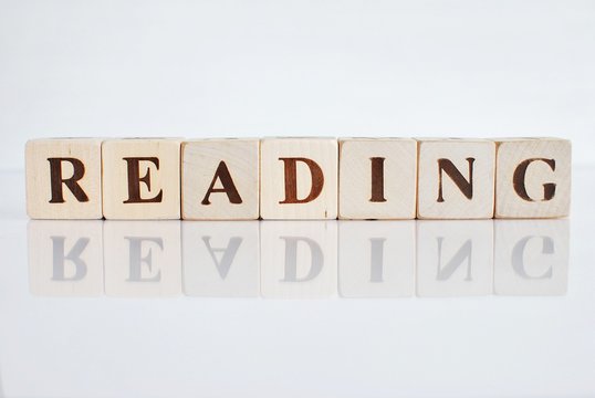 Word READING on white background with reflection.