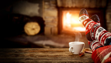 Fireplace And Slim Woman Legs With Christmas Socks 