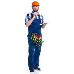 Wall Mural - Man worker builder with helmet and tool belt, notebook, pen on white background isolation