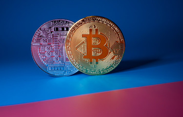 Bitcoin coins on a two-color background as the main symbol of the cryptocurrency.