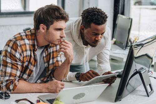 Cuadros en Lienzo two thoughtful multicultural programmers working at workplace together