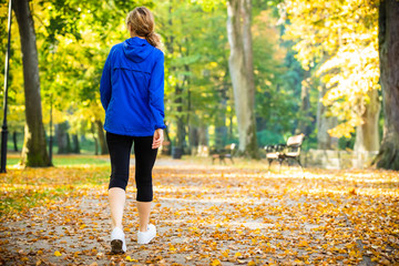 Wall Mural - middle-aged woman walking in city park