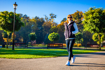 Wall Mural - middle-aged woman walking in city park