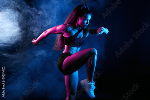 awesome sportswoman warming up before training, runner preparing for a compat...