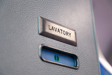 Vacant Green Sign, Vacant Symbol On An Airplane Lavatory Door. Raised, Brushed Metal Lavatory Sign, Recessed Plastic Vacant Sign. Toilet Room, Wc, Closet On Airplane Board
