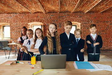 Wall Mural - attractive business people and their leader staning and looking at the camera, teamwork