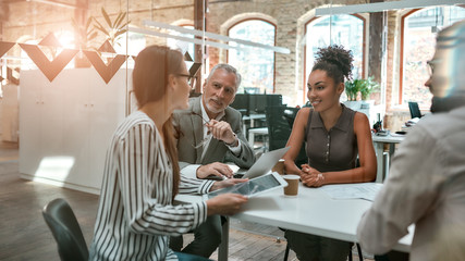 Brainstorming. Group of modern people discussing something and working together in the creative office