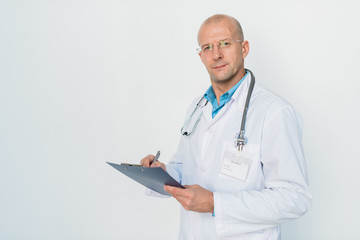 Aufkleber - Bald doctor in eyeglasses and whitecoat making prescriptions in document