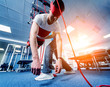 © romaset - Physiotherapy. Suspension training therapy. Young man doing fitness traction therapy with suspension-based exercise training system.
