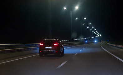 Wall Mural - car moves at high speed on a suburban highway