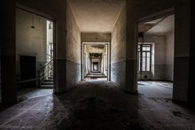 Indoors Shot Of An Abandoned Building With Dirty Walls And A Staircase On The Left