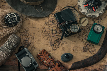 Fototapete - Old map, vintage travel equipment and souvenirs from the travel around the world 