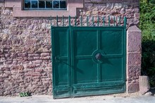 Wide Shot Of A Blue Gate Door Of A Brick House
