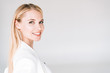 © LIGHTFIELD STUDIOS - smiling beautiful young blonde woman isolated on grey