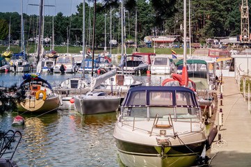 Wall Mural - Boats and yachts in a harbour on a sunny day.