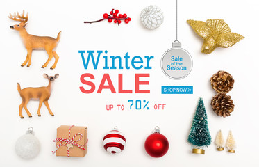 Wall Mural - Winter sale message with small Christmas ornaments on a white background